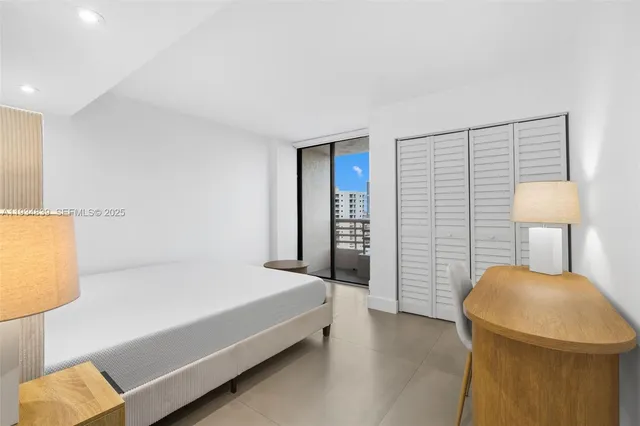 a bedroom with a bed and a lamp