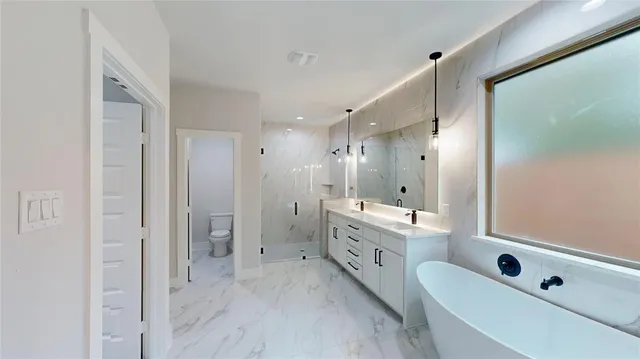 a bathroom with a double vanity sink mirror and shower