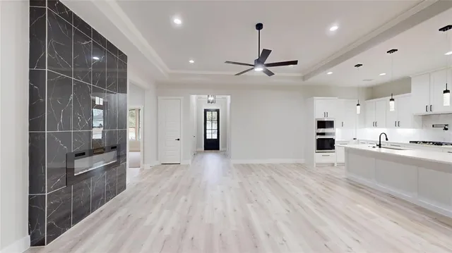 a large kitchen with kitchen island a sink stainless steel appliances and cabinets