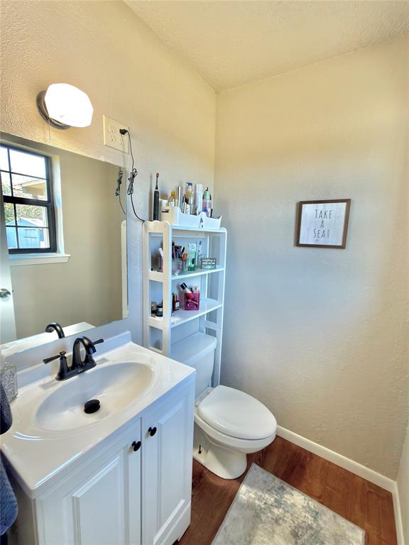 7615 Farm To Market 1499 Sumner, TX 75486 - Photo 8 of 18 a bathroom with a sink mirror vanity and toilet