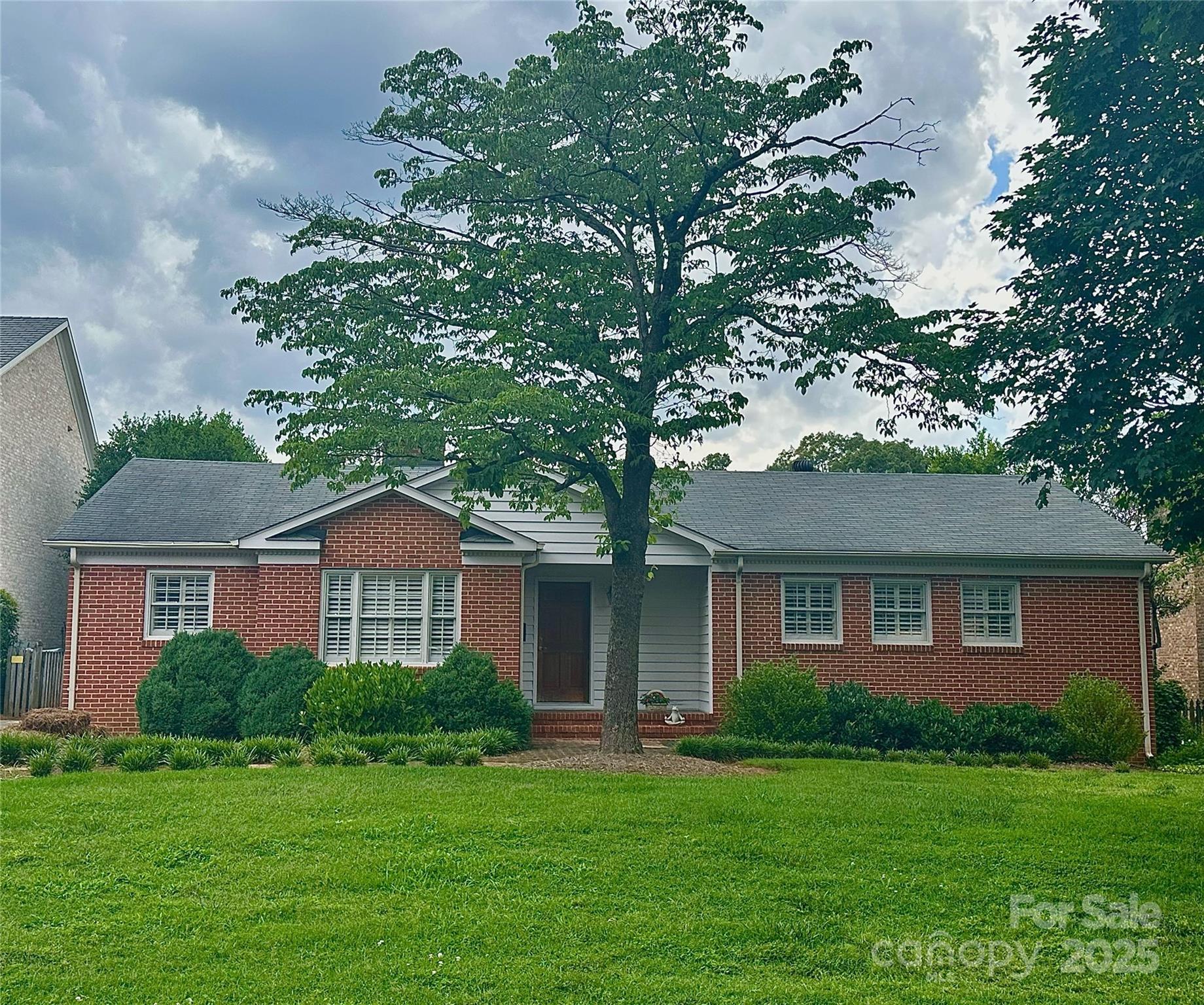 a front view of a house with a garden