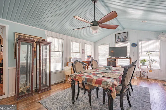 a view of a dining room with furniture window and wooden floor