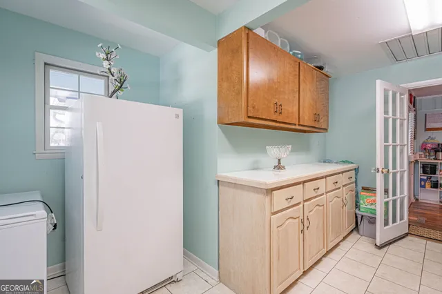 a utility room with cabinets washer and dryer