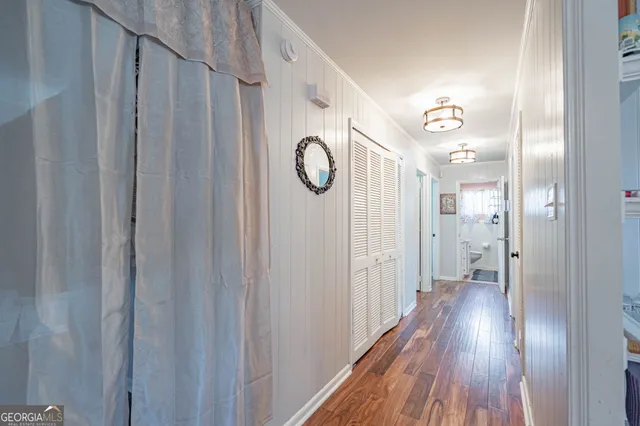 a view of a hallway with wooden floor
