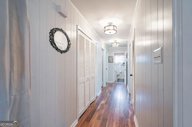 a view of a hallway with wooden floor
