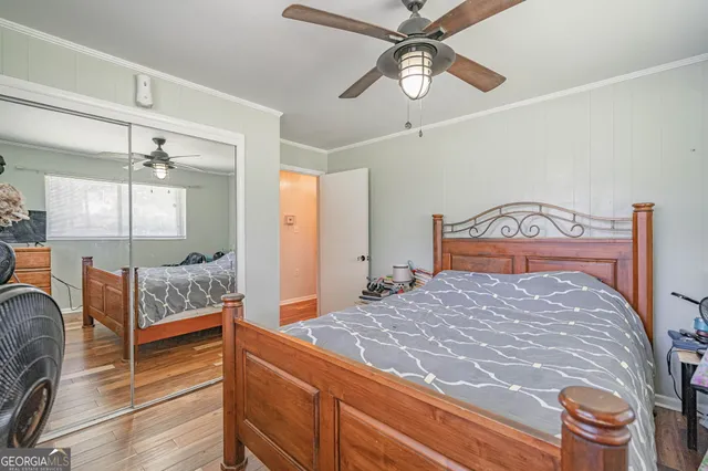 a bedroom with a bed and ceiling fan