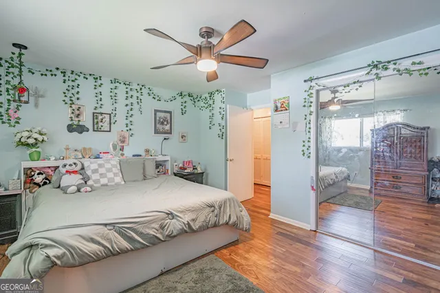 a bedroom with a bed and wooden floor