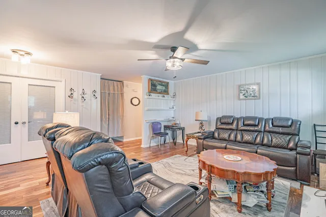 a living room with furniture a couch and wooden floor