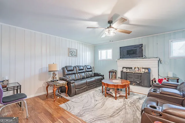 a living room with furniture fireplace and a window