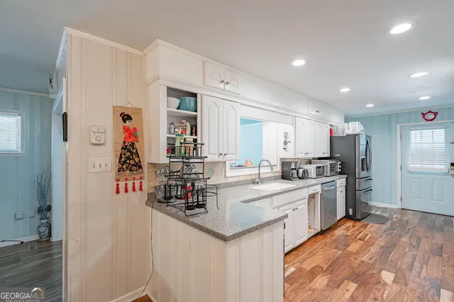 a kitchen with stainless steel appliances granite countertop a refrigerator and a stove top oven