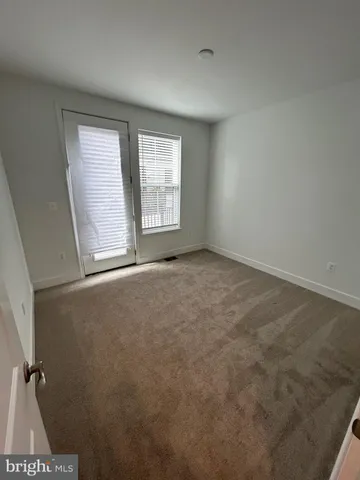 an empty room with a empty space and windows