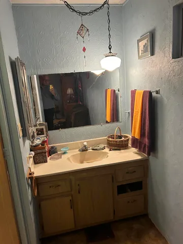a kitchen with granite countertop a sink a stove and cabinets