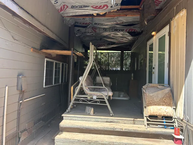 a view of living room with a floor to ceiling window and wooden floor