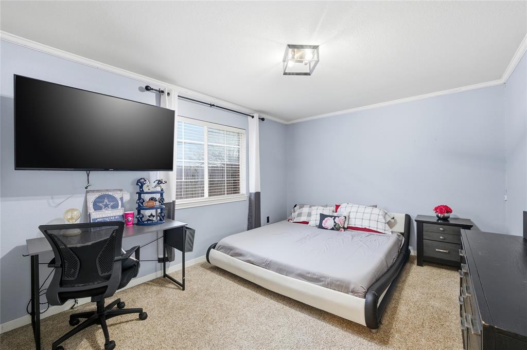 10504 Whitney Trace Drive Waco, TX 76708 - Photo 19 of 24 a bedroom with a bed and a flat screen tv