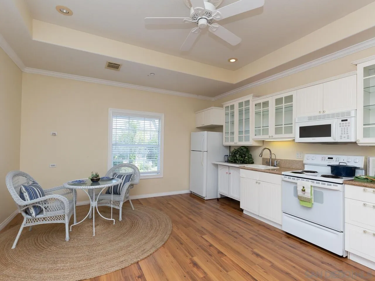 1732 Tavern Road Alpine, CA 91901 - Photo 16 of 60 a kitchen with a dining table chairs and white cabinets