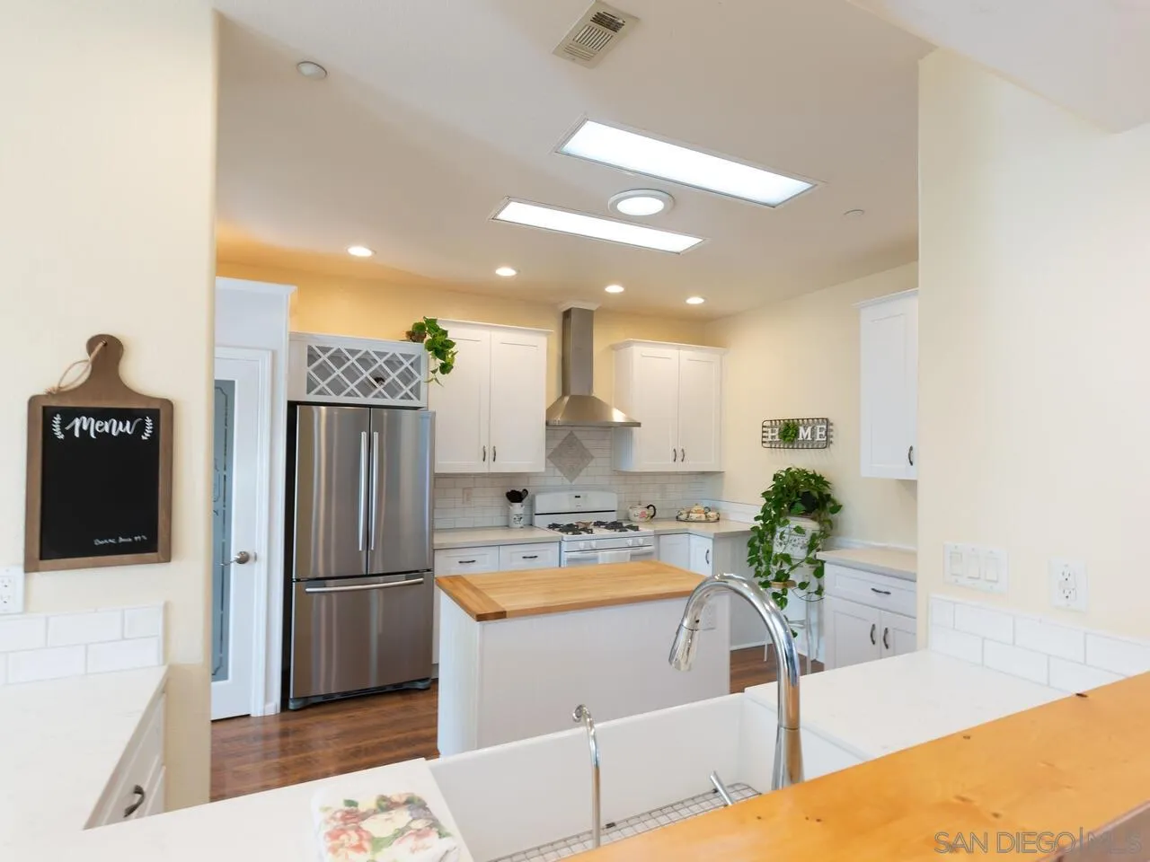 1732 Tavern Road Alpine, CA 91901 - Photo 34 of 60 a kitchen with stainless steel appliances kitchen island granite countertop a refrigerator a stove and a sink