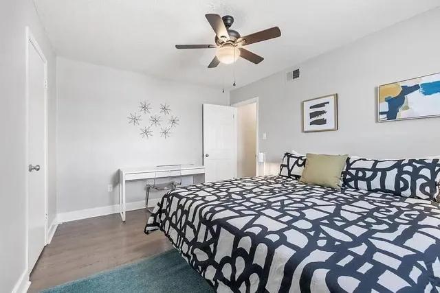 a bedroom with a bed and a chandelier