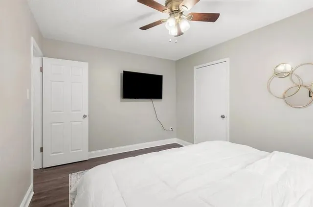 a bedroom with a bed and a flat screen tv