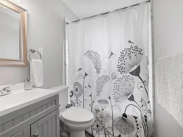 a bathroom with a sink and mirror with toilet