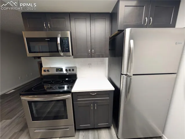 a kitchen with a refrigerator sink and microwave