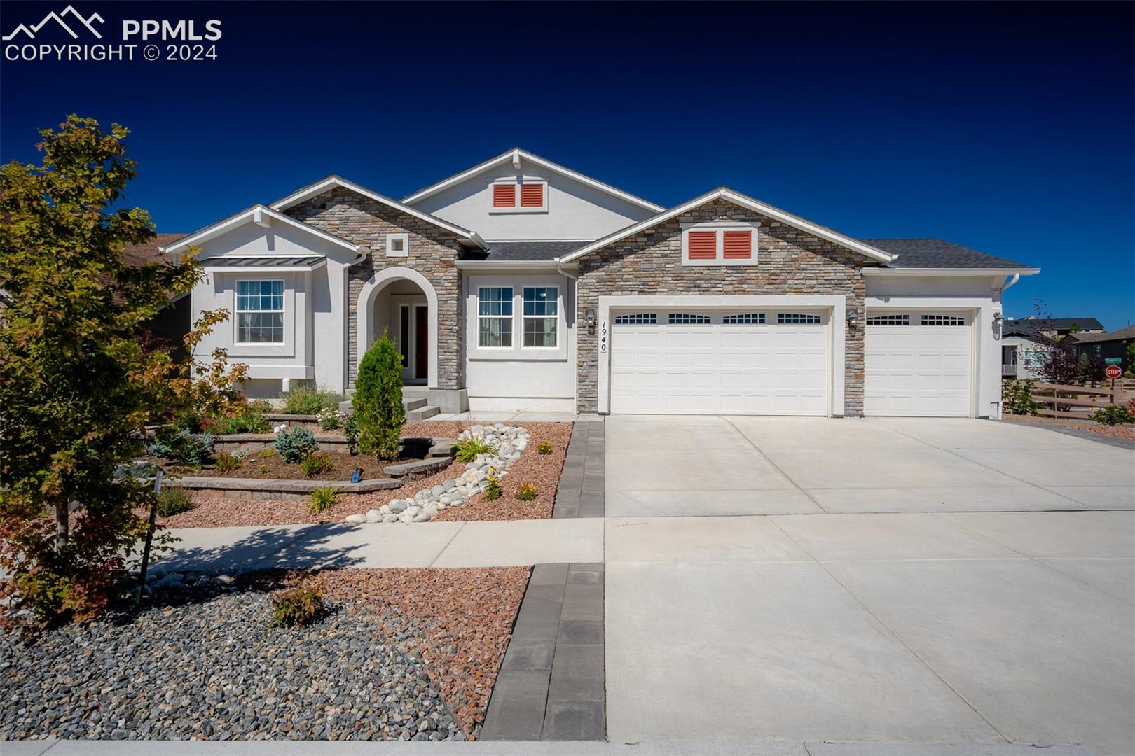 1940 Ruffino Drive Colorado Springs, CO 80921 - Photo 1 of 47 Front exterior with covered entry area, 3 car garage.