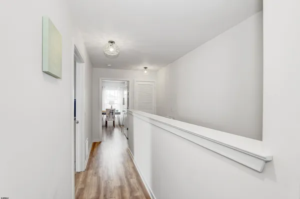 a view of hallway with wooden floor