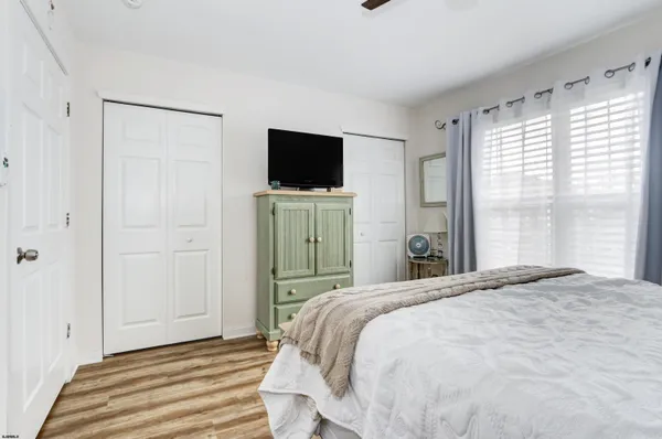 a bedroom with a bed and a television