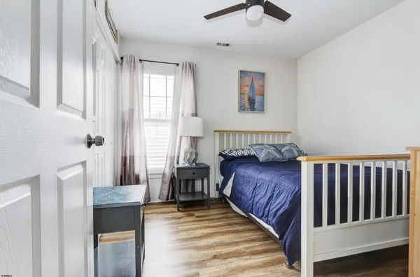 a view of a bedroom with wooden floor