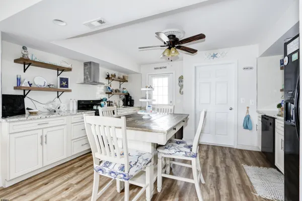 a view of a dining room with furniture and a chandelier