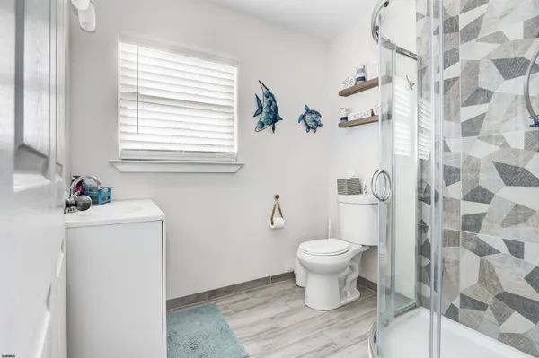 a bathroom with a white toilet sitting next to a white sink