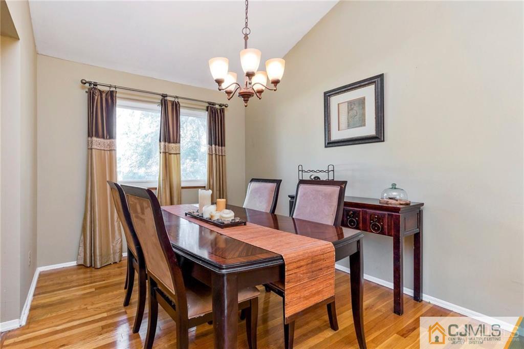 28 Appleman Road Somerset, NJ 08873 - Photo 13 of 25 a view of a dining room with furniture a chandelier and wooden floor