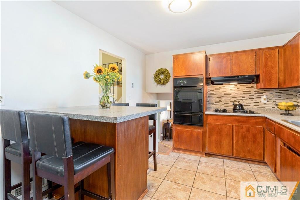 28 Appleman Road Somerset, NJ 08873 - Photo 14 of 25 a kitchen with stainless steel appliances granite countertop a stove a sink and a microwave