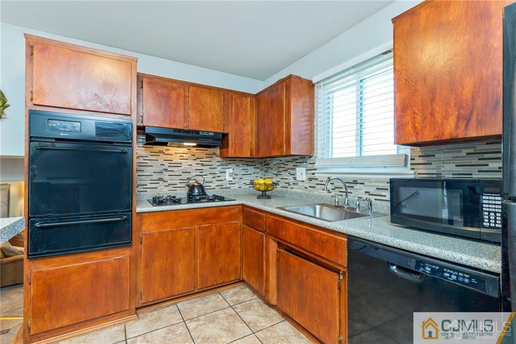 28 Appleman Road Somerset, NJ 08873 - Photo 15 of 25 a kitchen with stainless steel appliances granite countertop a refrigerator and a sink
