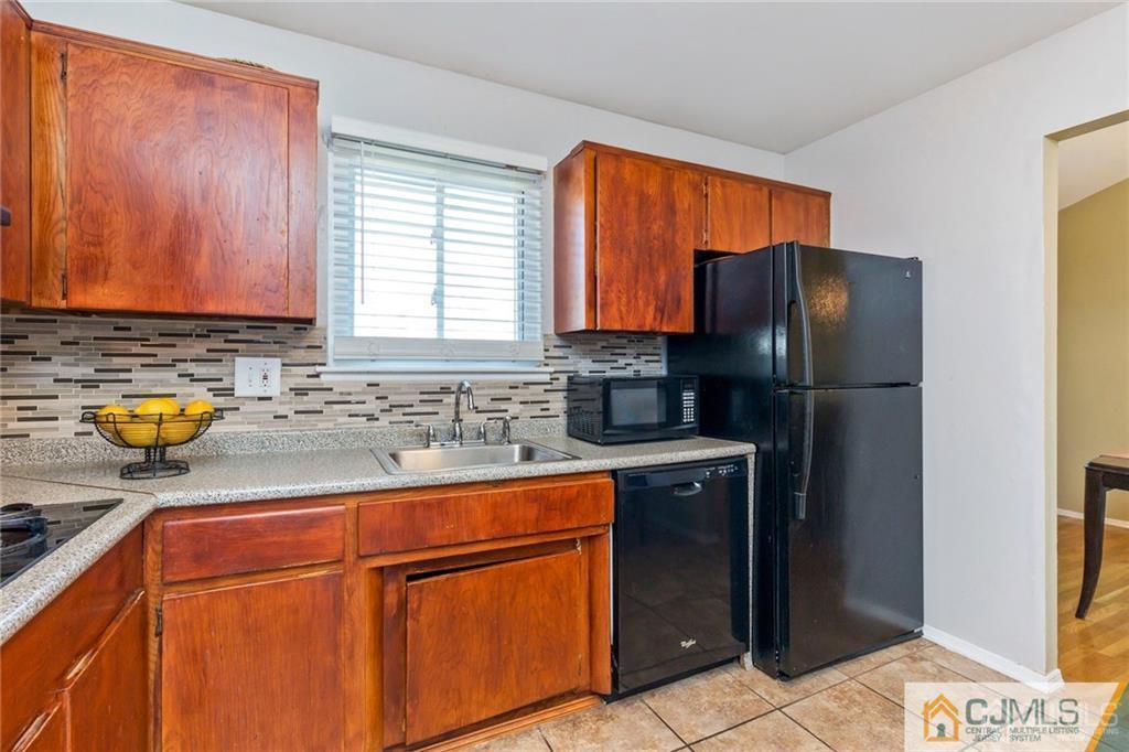 28 Appleman Road Somerset, NJ 08873 - Photo 17 of 25 a kitchen with stainless steel appliances granite countertop a refrigerator and a sink