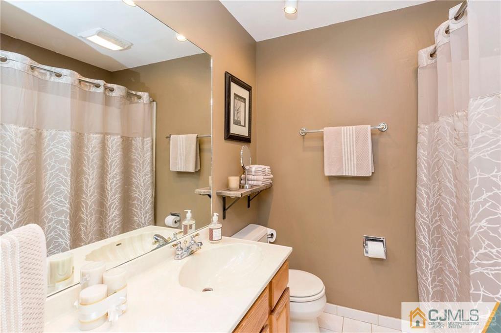 28 Appleman Road Somerset, NJ 08873 - Photo 22 of 25 a bathroom with a sink vanity mirror and toilet