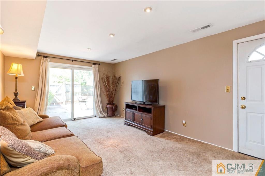 28 Appleman Road Somerset, NJ 08873 - Photo 3 of 25 a living room with furniture and a flat screen tv