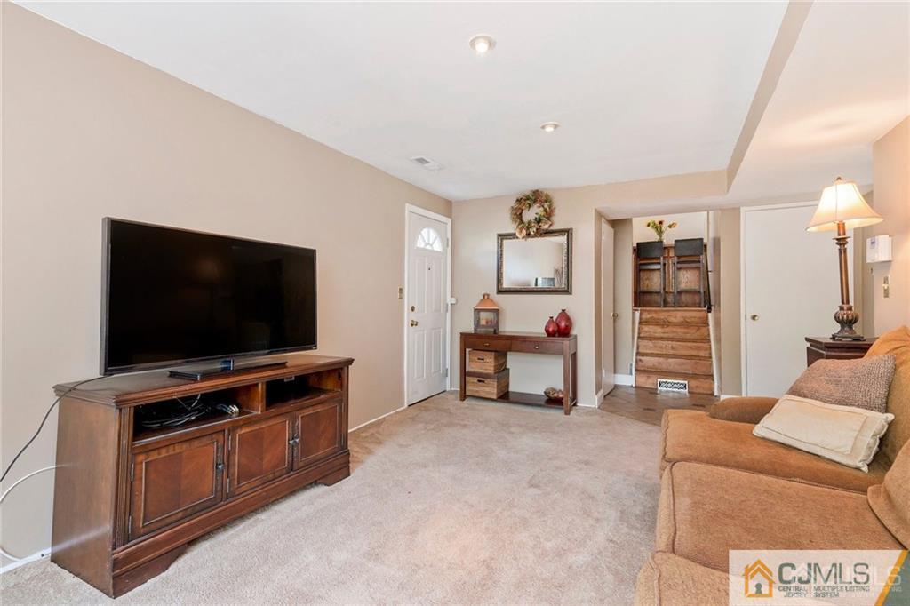 28 Appleman Road Somerset, NJ 08873 - Photo 5 of 25 a living room with furniture and a flat screen tv