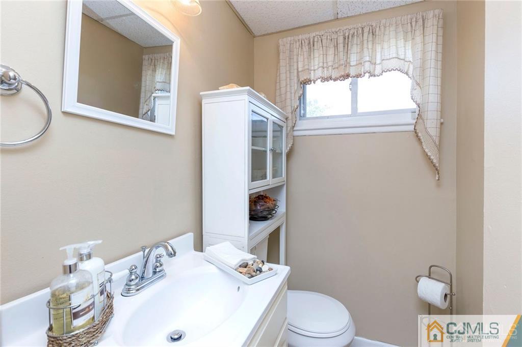 28 Appleman Road Somerset, NJ 08873 - Photo 8 of 25 a bathroom with a sink a toilet and mirror
