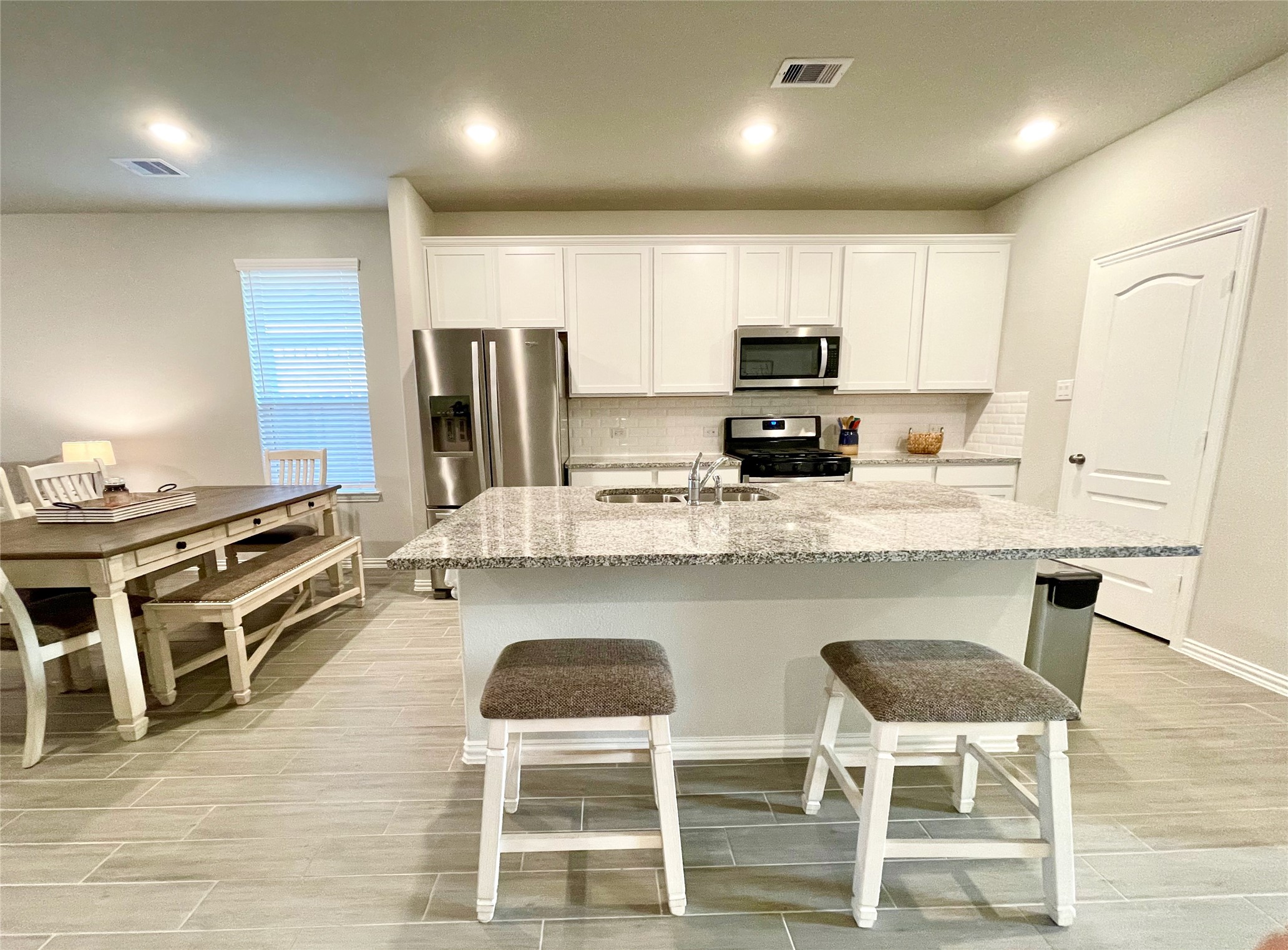 8319 Divot Trace Fulshear, TX 77441 - Photo 8 of 37 Modern kitchen with granite countertops