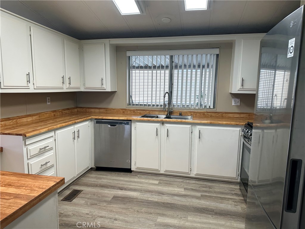 27701 Murrieta Road, Unit 268 Menifee, CA 92586 - Photo 8 of 24 a kitchen with granite countertop a sink stainless steel appliances and cabinets