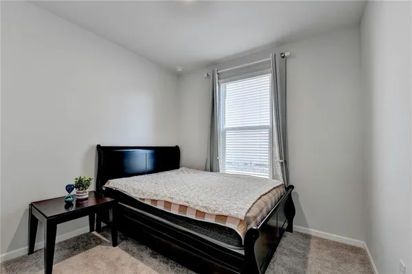 a bedroom with a bed and a chair