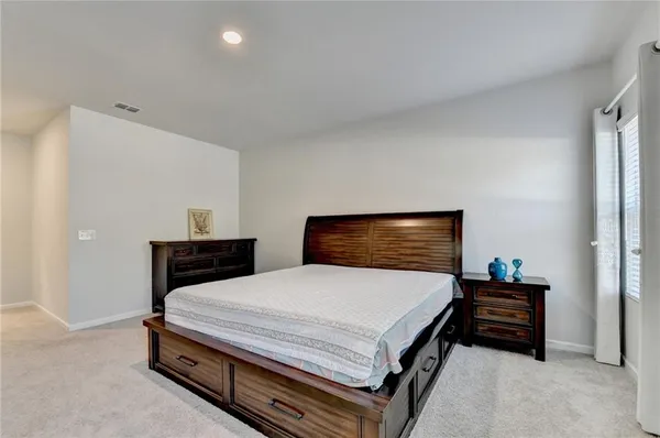 a bedroom with a bed and a lamp