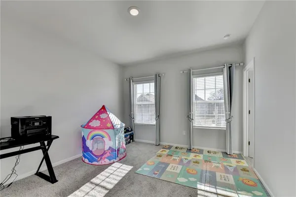 a bedroom with two beds and a window