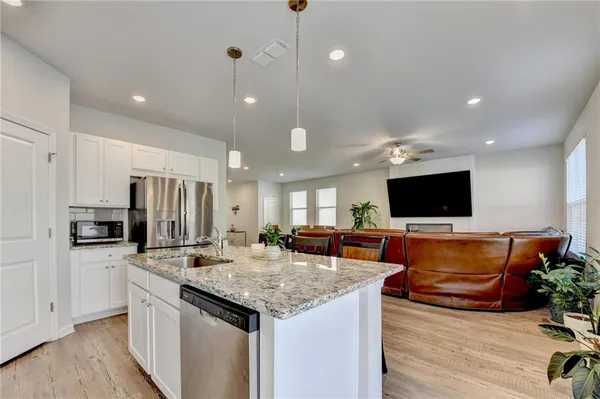 a kitchen with sink stove and refrigerator