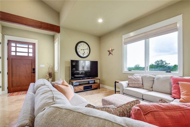 633 Trails End Road Johnson City, TX 78636 - Photo 8 of 29 Gleaming tile floors and vaulted ceilings with rich wood accents define this welcoming space.