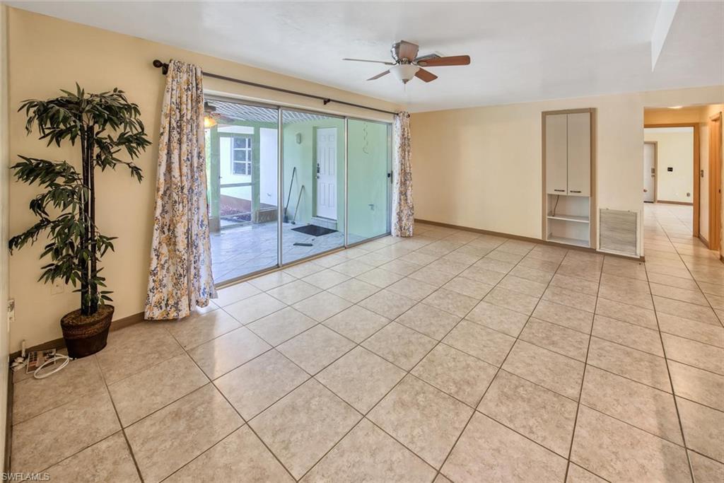 29 Caribbean Road Naples, FL 34108 - Photo 9 of 32 Unfurnished room with light tile patterned flooring and ceiling fan