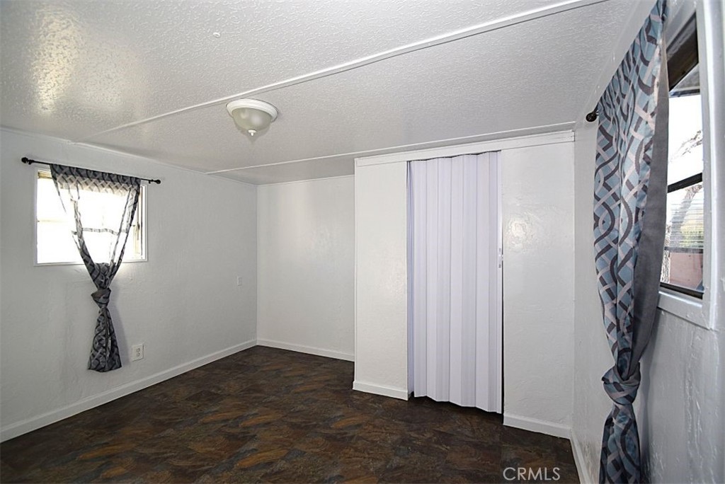 6426 Valley View Street, Unit 39 Joshua Tree, CA 92252 - Photo 7 of 11 a view of empty room with windows and wardrobe