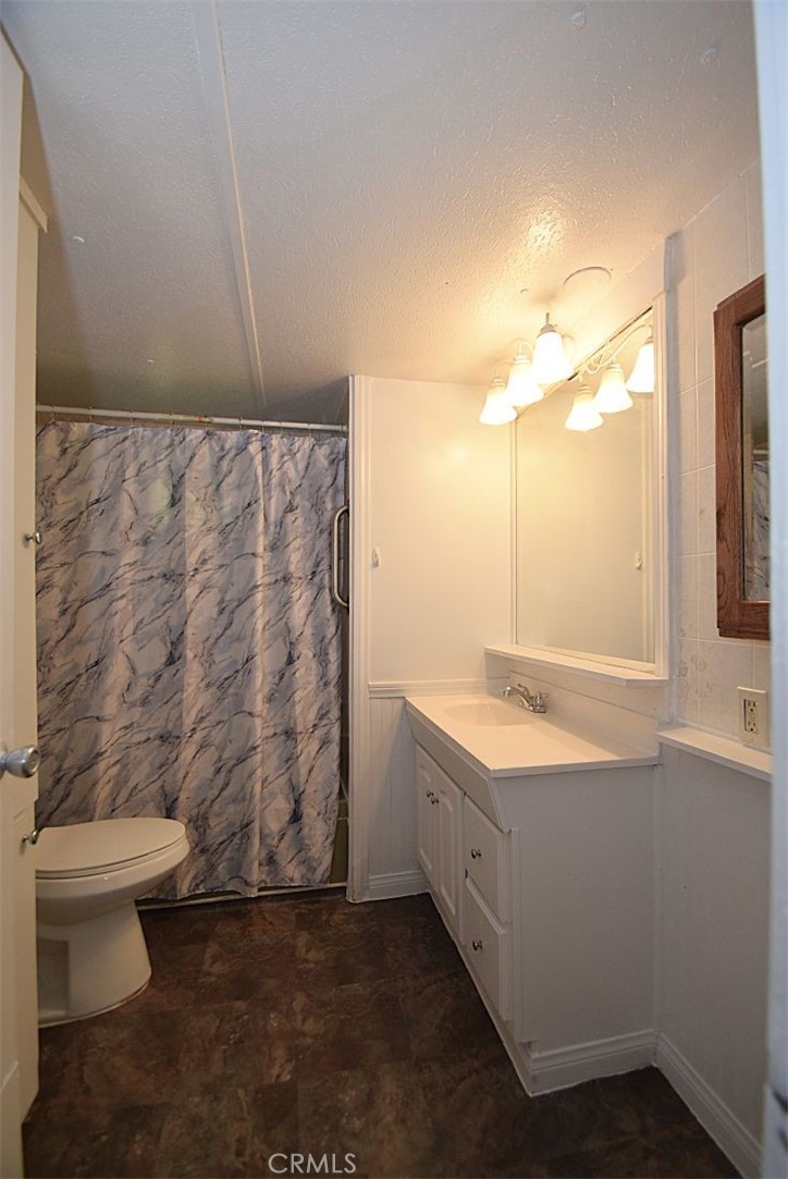 6426 Valley View Street, Unit 39 Joshua Tree, CA 92252 - Photo 8 of 11 a bathroom with a granite countertop sink and a toilet