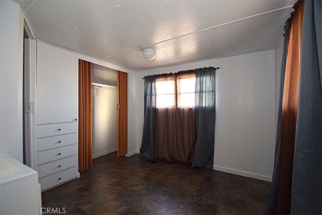 6426 Valley View Street, Unit 39 Joshua Tree, CA 92252 - Photo 9 of 11 an empty room with closet and mirror