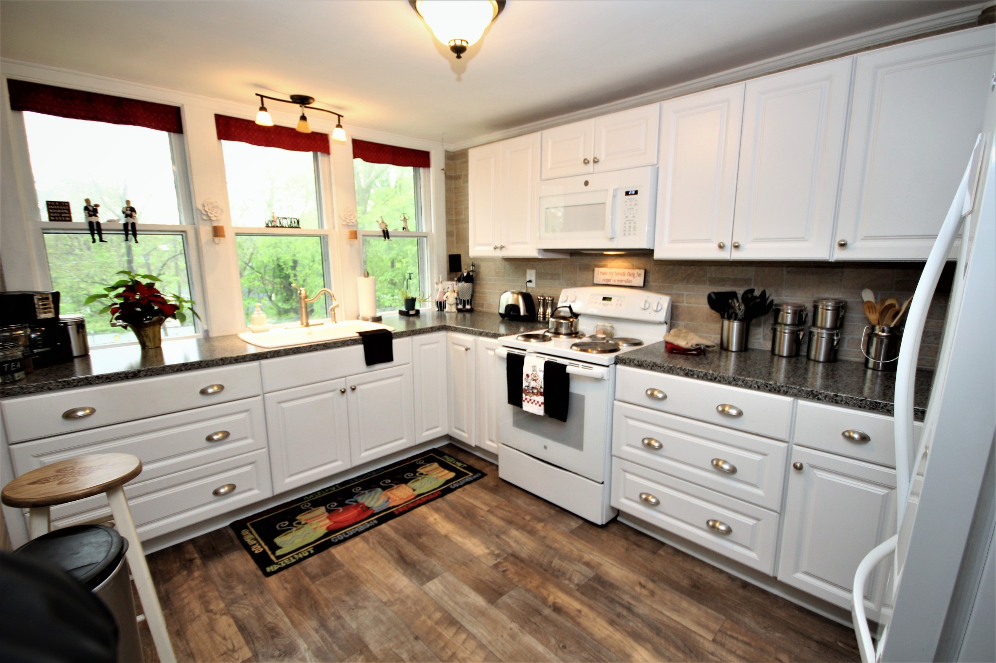 312 North Main Street Springfield, TN 37172 - Photo 35 of 47 a kitchen with granite countertop white cabinets white appliances a large window and a sink
